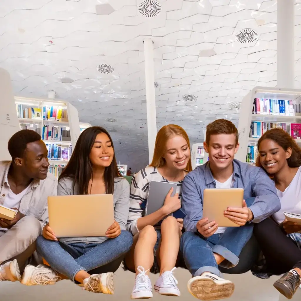 cours-particuliers-physique-chimie-terminale-5 élèves assis par terre tenant des livres et ordinateurs dans la main